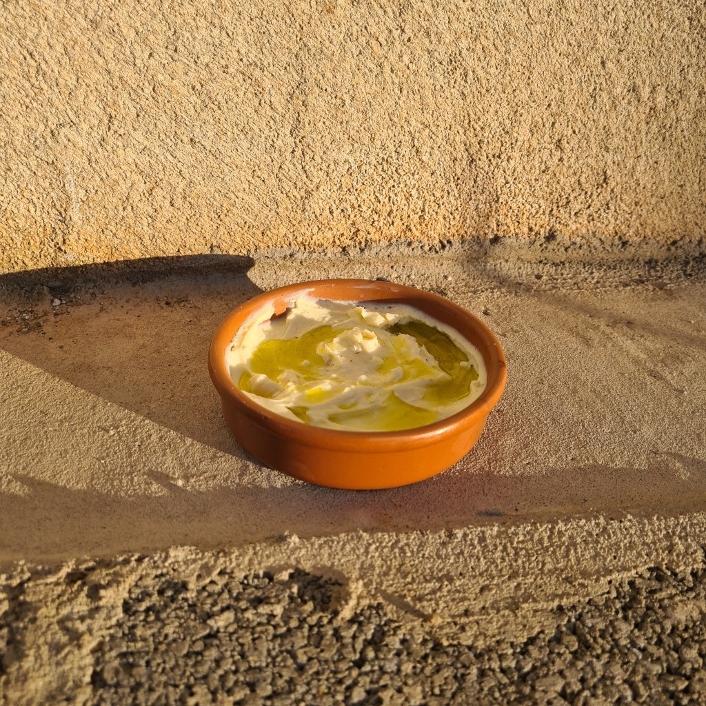 Kefir Labneh with Extra Virgin Olive Oil in a terracotta dish