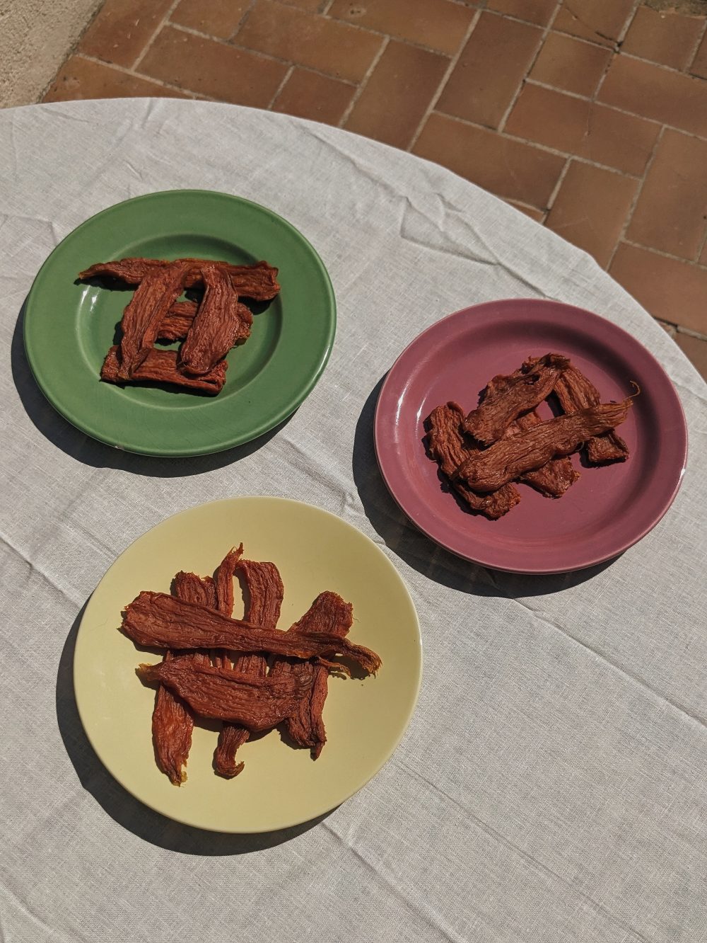 a trio of plates with strips of sun dried sweet potato