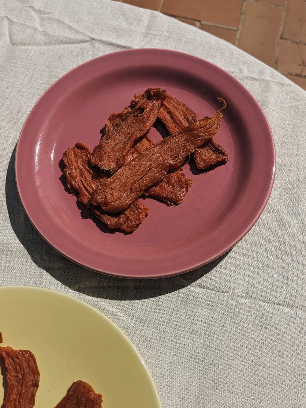 orange sun baked sweet potato on a pink plate